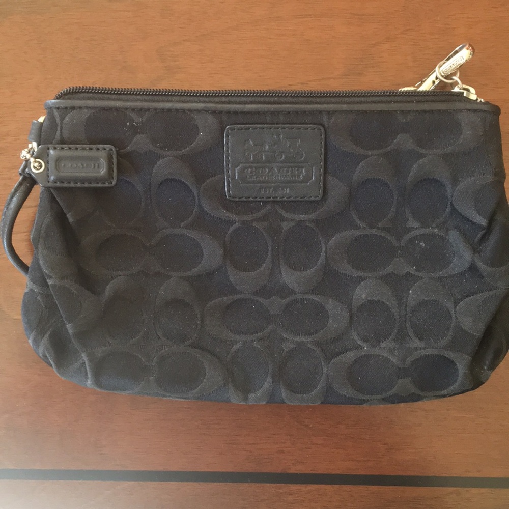 Coach wristlet with black signature pattern